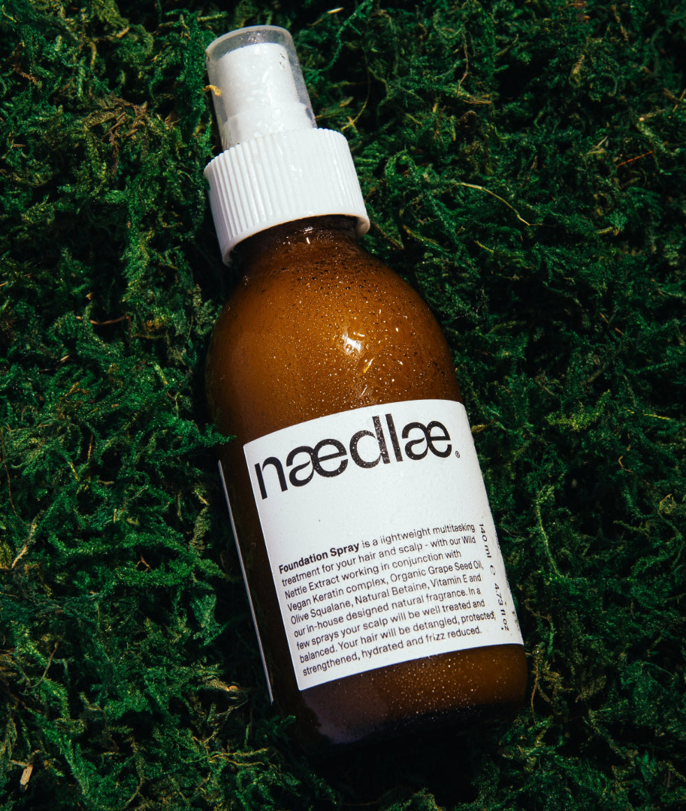 Naedlae Foundation Spray natural leave in conditioner spray in amber bottle with white label on green background